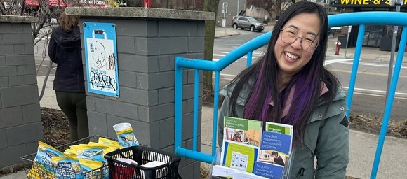 Community Recycling Ambassador sharing information at a table at a community event