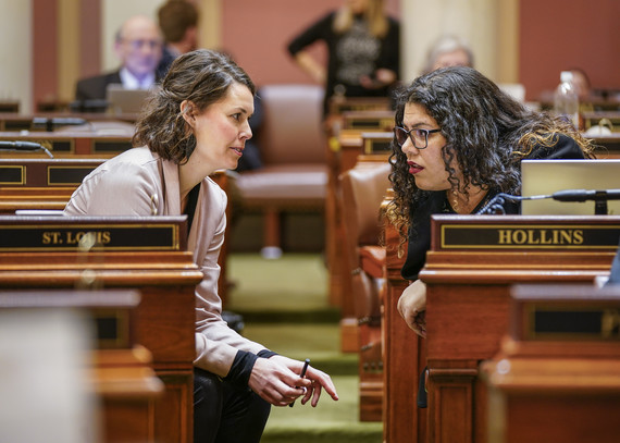 Rep. Liz Olson and Rep. Athena Hollins talk on the House Floor