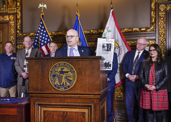 Lislegard holds up 2021 Star Tribune at Governor's Signing Ceremony