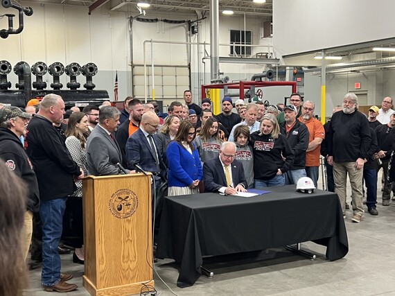 Group surrounds Gov. Walz as he signs refinery safety bill