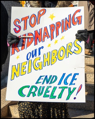 Protestor holding a sign reading "Stop kidnapping our neighbors End ICE cruelty