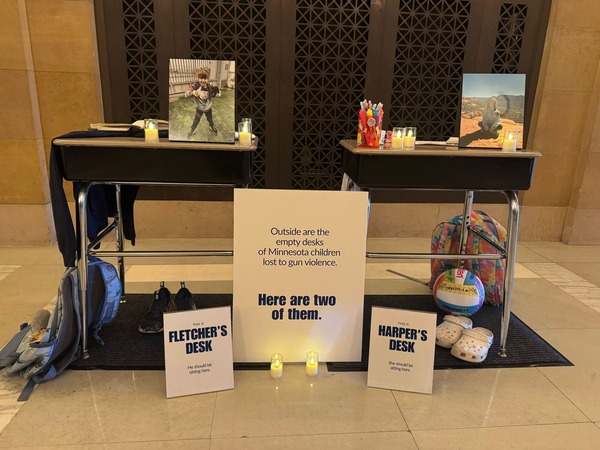 School desks with photos of Harper and Fletcher, candles, backpacks, a volleyball, and markers/crayons