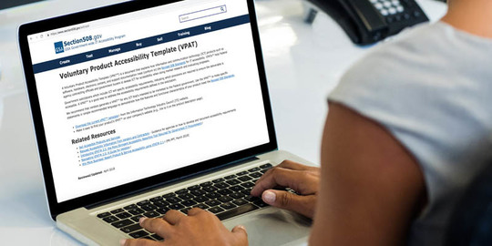 Person reading the Voluntary Product Accessibility Template (VPAT) webpage on the Section 508 website.