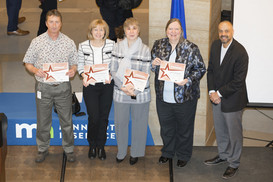 MNIT Partnering with DHS’ EAQAT Team posing with Commissioner Tomes and their certificates.