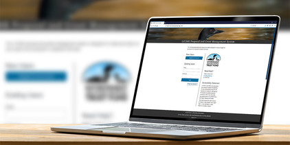 Laptop displaying LCCMR website on the screen.