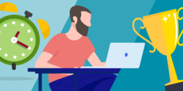 Man seated, working on a laptop. Overhead: alarm clock and a trophy.