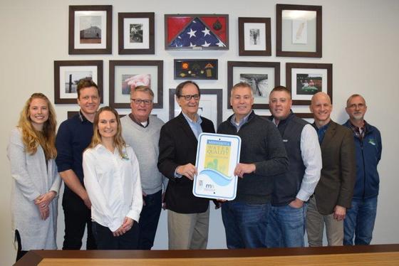 Staff and Commissioner Frederickson pose with representatives of Forsman Farms 
