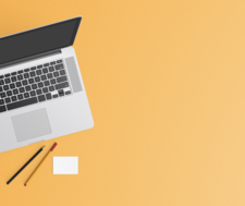 Computer with notepad and pencil