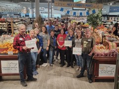 Mackenthuns's Fine Foods staff with their Minnesota Grown foods section.