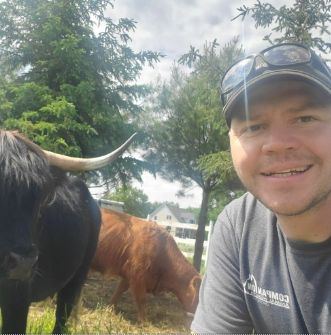 Josh snapping a selfie with some of his cows. 