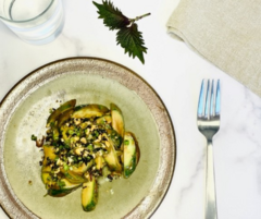 Cucumbers with peanut sauce: A salad on a green plate with a white marble background.