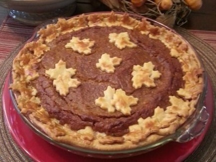 A squash pie with maple-leaf shaped decorations made out of pie crust.