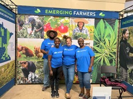 Four people standing in front of banner