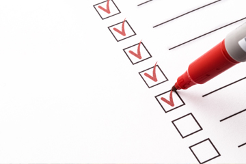 check marks on white paper with red pen