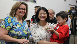 Noemi Trevino, Asst. Commssioner Hue Nguyen help pack school supplies and food at the Sheridan Story warehouse
