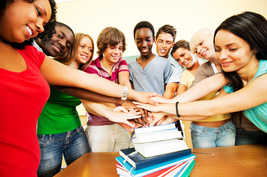 Students putting their hands together