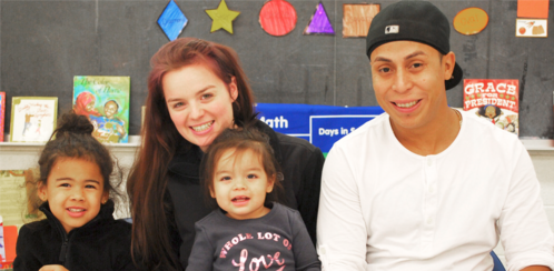 Parents smiling with their two young children