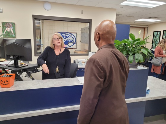 Commissioner Willie Jett speaks with a woman at the front desk. 