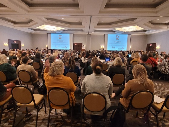 A crowd of people watch as Commissioner Willie Jett speaks from the podium