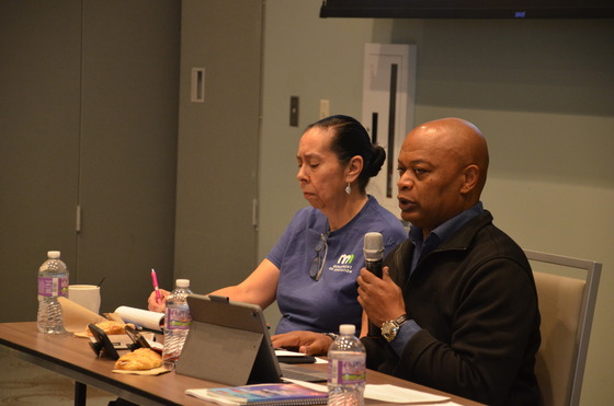 Commissioner Willie Jett speaks into a microphone