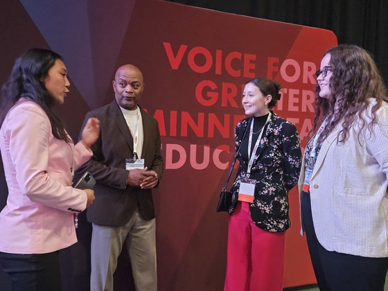 Commissioner Jett speaks with three young women