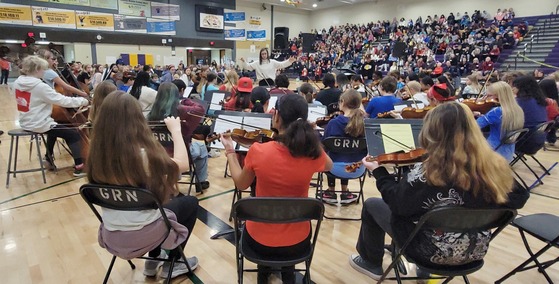 A woman leads an orchestra during the veterans day ceremony