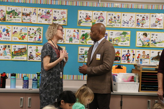 Commissioner Willie Jett speaks to kindergarten teacher Linda Schwartz