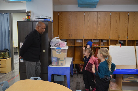 Commissioner Jett speaks to pre-kindergarten students as they prepare to go play outside