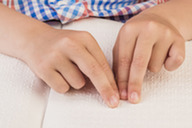 boy reading braille