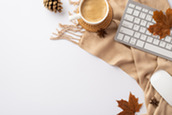 Image of desk with fall items and computer