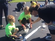 kids and adults painting pavement
