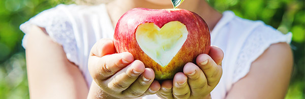 girl holding apple