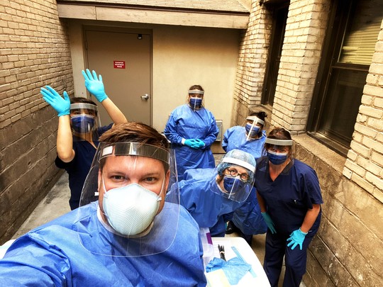 A team of healthcare providers in masks and face shields.