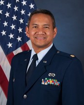 Fernando Nacionales, a middle-aged Latinx man with close-cropped hair, smiles into the camera, wearing a military uniform.