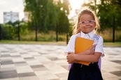 School girl holding book