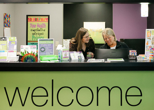 Photo of smiling providers and the front desk at WeARE - the Clinic