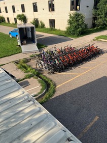 Many bikes being unloaded from a trailer