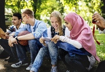 Teens sitting on a curb