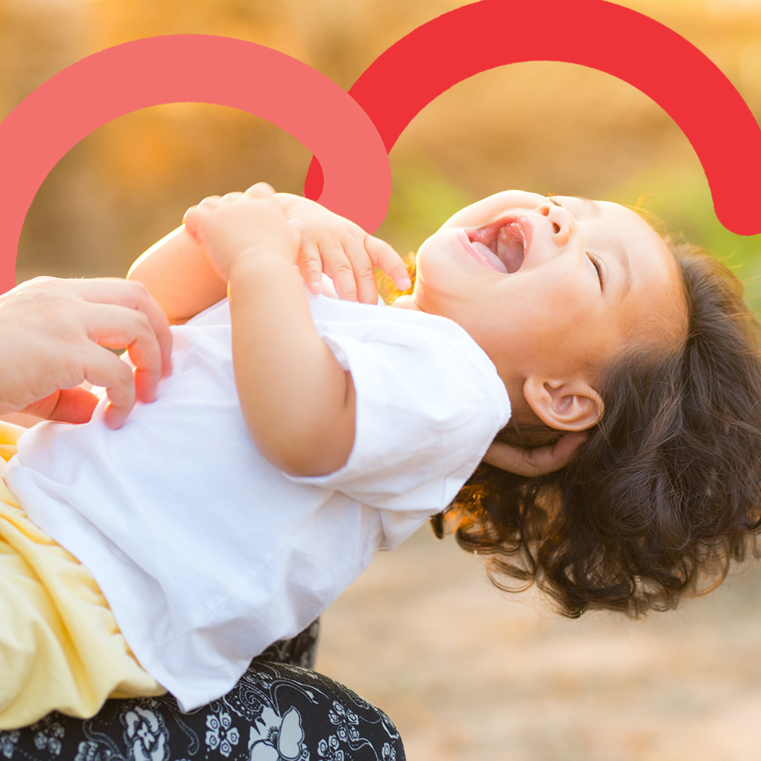 toddler being tickled laughing 