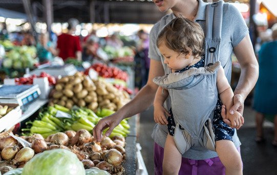 mom with baby in carrier at farmer's market 