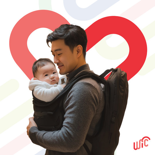 man with baby in carrier on chest 