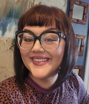 Amanda Ubongen, woman with short brown hair and glasses 