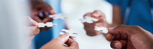 hands holding puzzle pieces