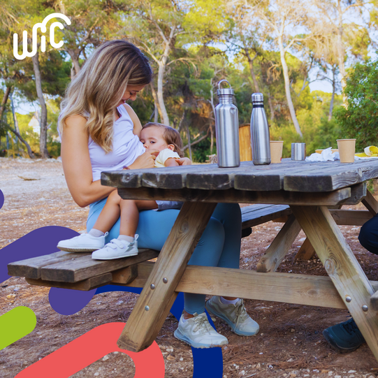 woman nursing on picnic table 