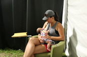 mom nursing baby at state fair tent