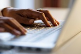 hands typing on computer