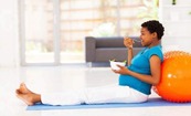 pregnant woman sitting eating from bowl