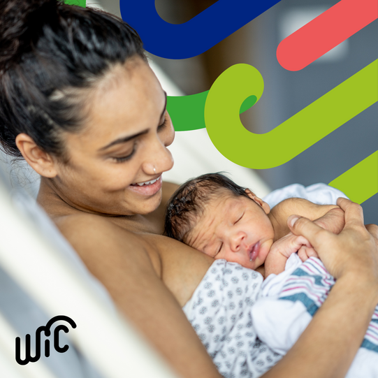mom holding infant in bed