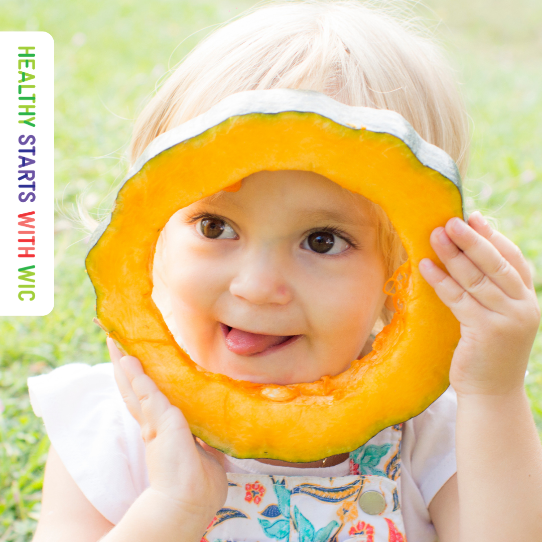 child holding up squash 