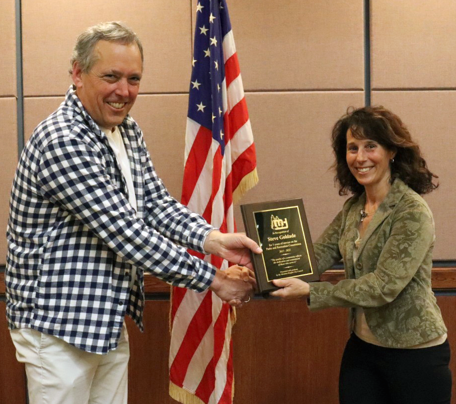 Steve Goldade accepting a recognition plaque from Mayor Levine in the City Council Chambers.